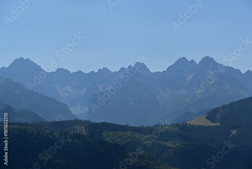 Fototapeta Naklejka Na Ścianę i Meble -  High Tatras seen from a metal observation tower with a modern glass terrace offering a stunning panorama at Poronin, Poland. Majestic mountains peaks of High Tatra moutnains.