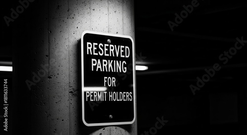 Monochromatic Reserved Parking Sign Displayed On A Concrete Column In A Dark Space