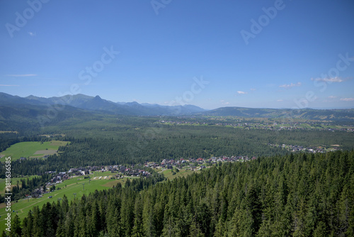 Fototapeta Naklejka Na Ścianę i Meble -  High Tatras and Male Ciche ski resort seen from a metal observation tower with a modern glass terrace offering a stunning panorama at Poronin, Poland. Majestic mountains peaks of High Tatra moutnains.