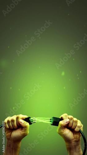 Hands holding power cord with green electric sparks