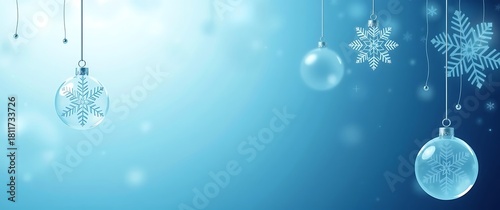 Hanging glass ornaments and snowflakes on a blue winter background