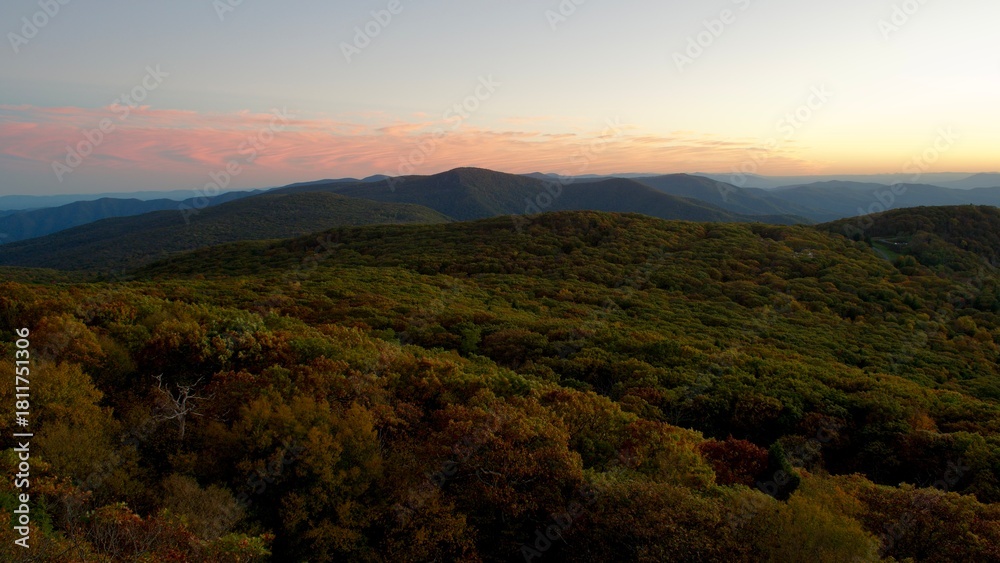 Naklejka premium Dusk settles over Shenandoah. The sun sets beyond the mountains in this expansive autumn view from Shenandoah National Park, Virginia. 