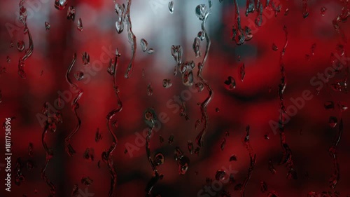 Rain days, rain falling on window surface on red and horror background. Concept of sad, nostalgic, reflective, crying, pensive, depressive, thoughtful, horror, crime.
