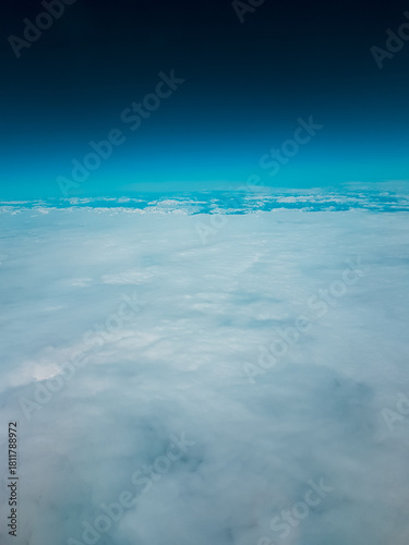 Low earth orbit above the horizon turquoise green space and white clouds