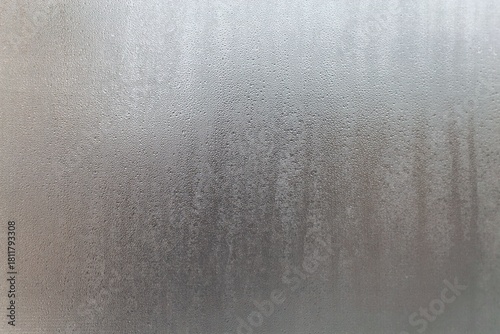 A close up of a glass window with water droplets on it