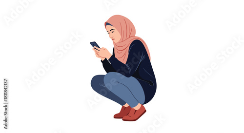 Thoughtful young Muslim woman in a hijab squatting down and intently looking at her smartphone in a casual urban setting.