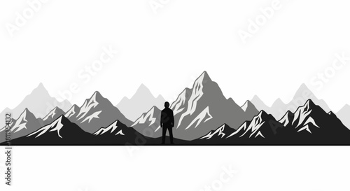 Silhouette of a person standing before majestic mountain range.