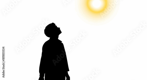 Silhouette of a person looking up at the bright sun in the sky.
