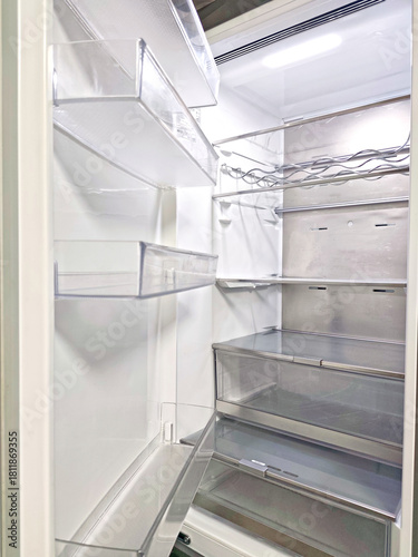 Wallpaper Mural Clean, empty refrigerator interior with transparent plastic shelves, metal wine rack, clear storage drawers, and LED lighting. Modern kitchen appliance with organized compartments and minimalistic des Torontodigital.ca