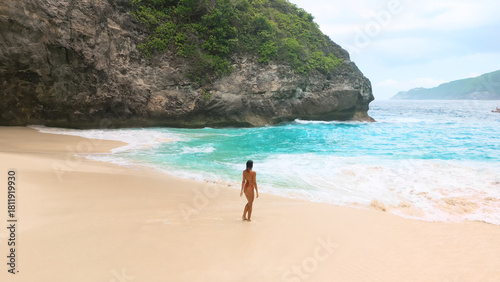 Rear View Nude Woman On Secluded Tropical Beach With Turquoise Surf