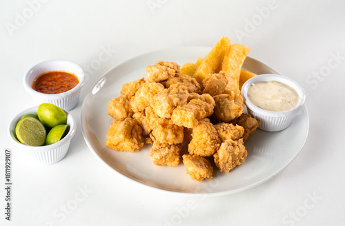 Peruvian food: chicharron de pescado or fish cracklings. White background