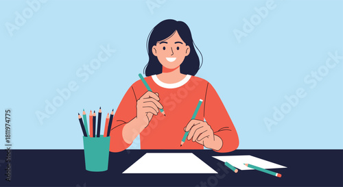 Happy young woman sitting at a desk and drawing with colored pencils enjoying her creative hobby or working as an artist.