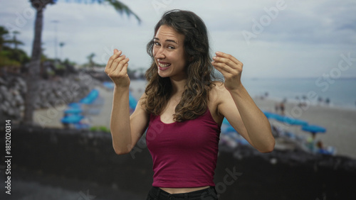 Woman tossing banknotes with both hands while smiling broadly and showing palm gesture on street; extravagance.