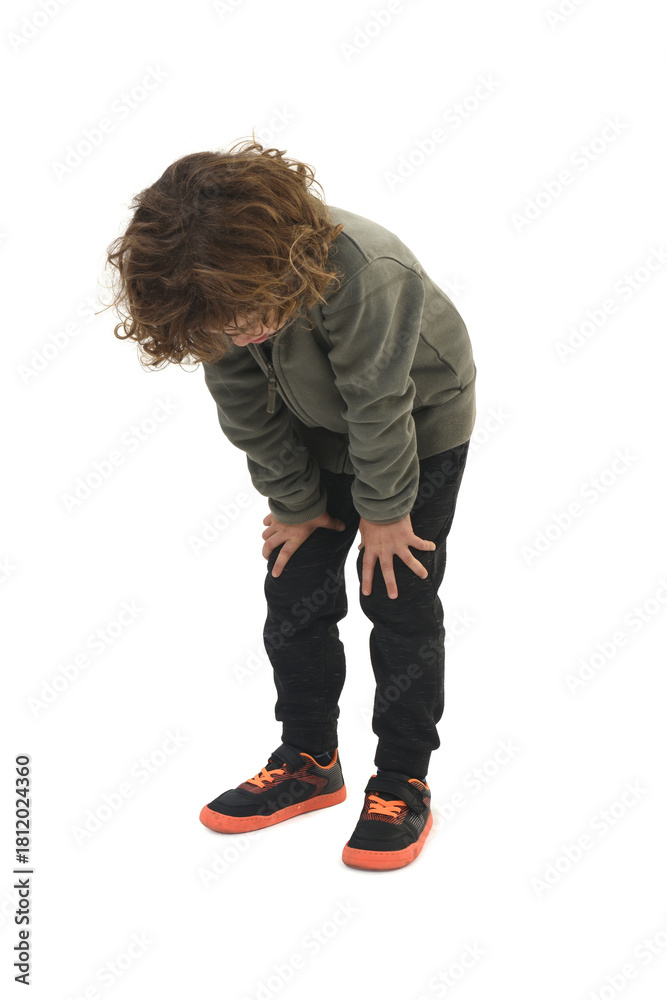 Naklejka premium bent over Child standing bent over looking down on white background