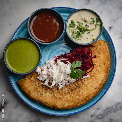 Besan chilla served with an assortment of flavorful chutneys—healthy, savory, and a classic Indian breakfast delight.