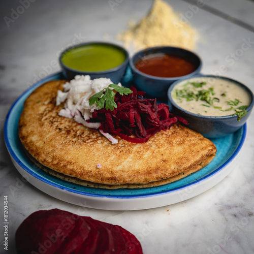 Besan chilla served with an assortment of flavorful chutneys—healthy, savory, and a classic Indian breakfast delight.