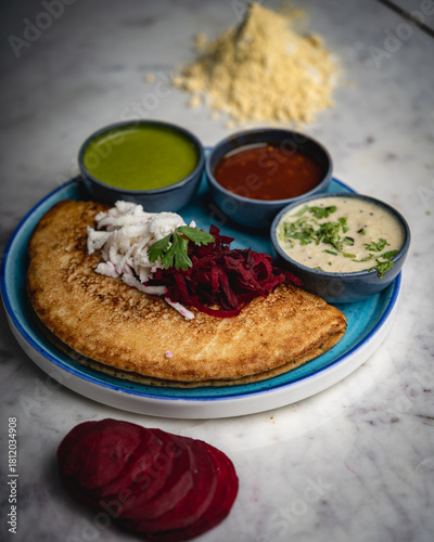 Besan chilla served with an assortment of flavorful chutneys—healthy, savory, and a classic Indian breakfast delight.