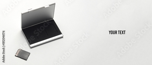 Box holder with SD memory card on a gray background. Copy space