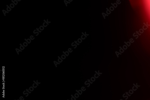 Sharp red light leak emerging from upper right corner with precise gradient definition and warm luminous glow fading into pure black. Authentic film photography effect showcasing clean corner light pe