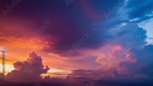 This breathtaking wide shot captures a magnificent sky at dusk or dawn, showcasing an extraordinary spectrum of natural color. Billowing clouds are illuminated with a stunning gradient, shifting seaml