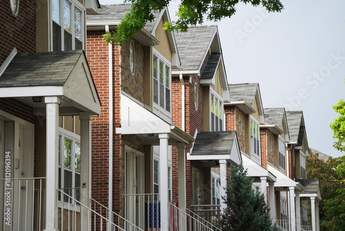 Canvas Print Street view of multiple similar single family homes in a housing development lined up in a row