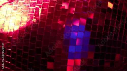 This captivating photo of a disco ball illuminated with colorful lights enhances the dance floor vibes, inviting a celebration of music, movement, and connection.