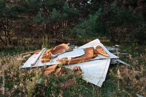 Illegal construction waste dumped in a forest, highlighting pollution and improper disposal in nature.