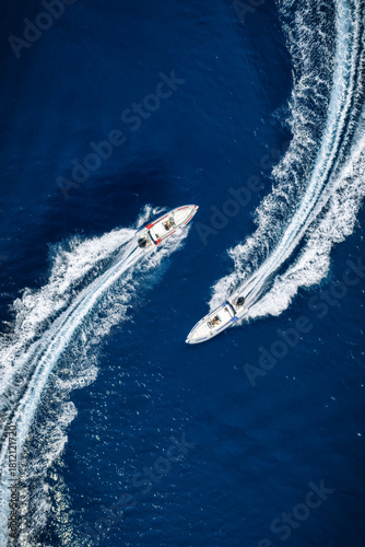 Bild auf Leinwand Aerial overhead view of two RIB speedboats racing over the ocean and leaving a t