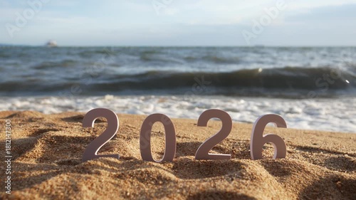 number 2026 for new year sign on summer beach at sunset, with ripple sea wave and beautiful nature at background, 2026 New Year celebration concept