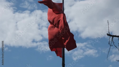 The footage features a vibrant Turkish flag waving prominently under a clear blue sky, symbolizing national pride and identity in an open landscape.
