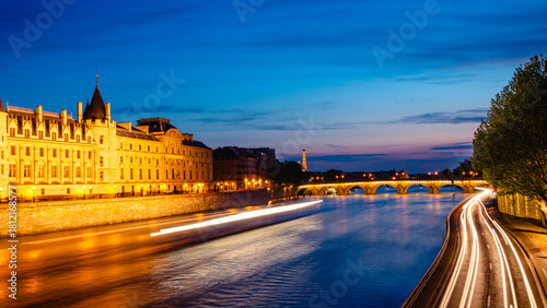 View of Paris by night with the Seine river and the Conciergerie building