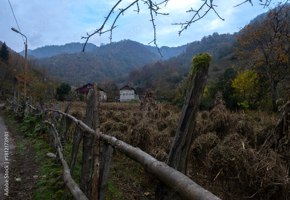 Fototapeta premium Rural autumn landscape with old wooden fence in mountain village