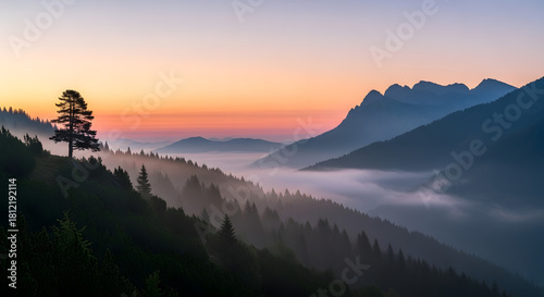 A breathtaking view of mountains covered in mist at the sunset time