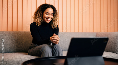 Happy Young Female Candidate Having Online Video Job Interview On Tablet In Modern Office Lounge
