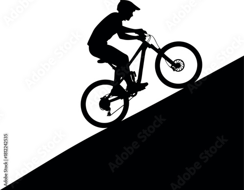 Silhouette mountain biker descending steep hill