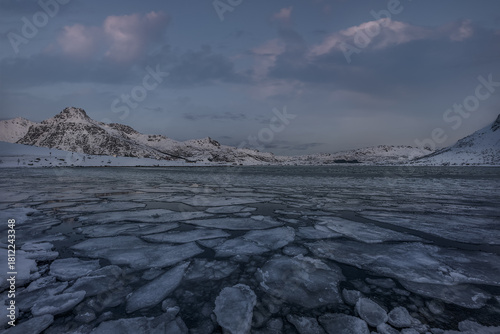 Wallpaper Mural Frozen Arctic Lake with Layered Sea Ice and Snow-Covered Mountains under a Soft Winter Sky in Northern Norway Torontodigital.ca