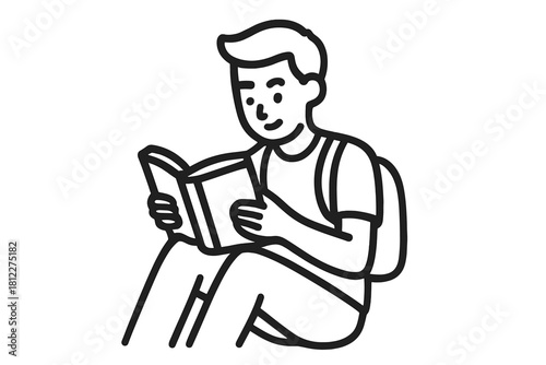 Young student sitting comfortably while reading an open textbook for education