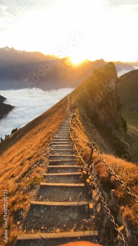 Sunset on the ridge hike from Stoos with a stepped path in the foreground and a breathtaking sea of fog in beautiful autumn time