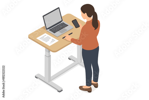 Businesswoman using a smartphone and laptop at a modern ergonomic standing workstation