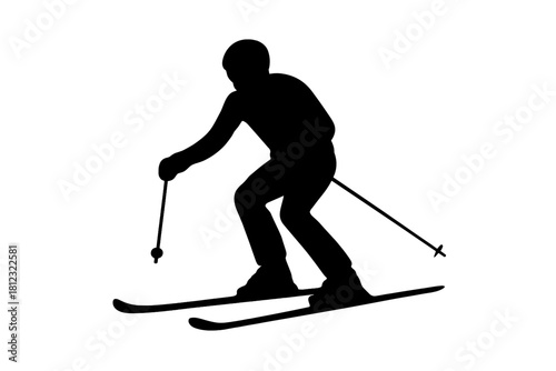 Black silhouette of a skier descending a steep slope during winter sports activity