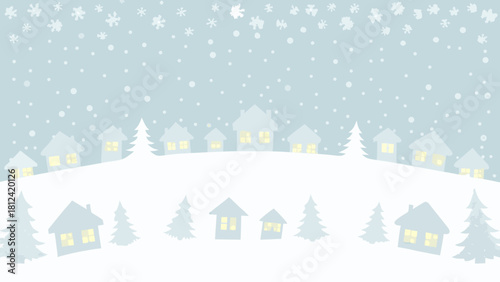 Winter village scene with snow falling on houses and trees in a peaceful christmas landscape