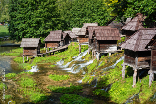 Small water mills on poles at Pliva lake, tourist destination near Jajce