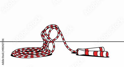 Jump rope on white backdrop, striped jump rope lies tangled yet ready for action. The jump rope is a symbol of fitness, exercise, and childhood fun.