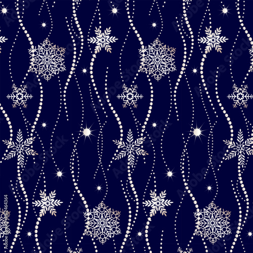 A wonderful Christmas ornament for textiles. pattern with silver snowflakes in an abstract design on a blue background.