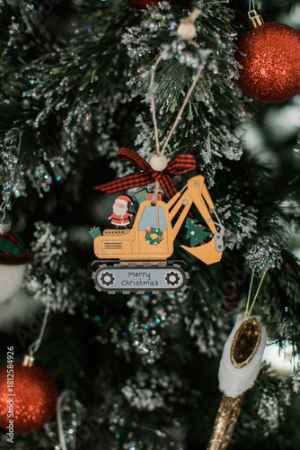 Bulldozer ornament on a christmas tree with a santa claus 