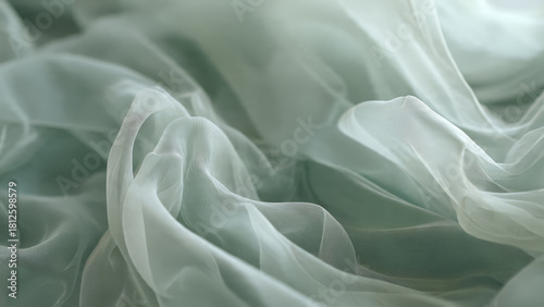 Beautiful ethereal light green sheer fabric with soft, delicate waves and gentle folds, creating a dreamy and elegant texture.