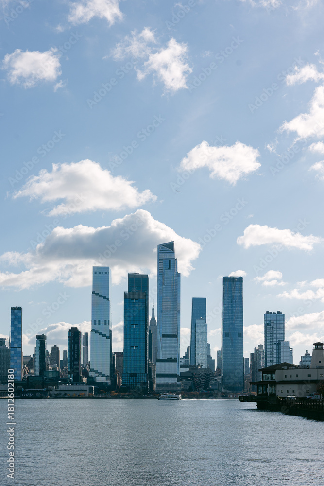 Fototapeta premium Skyscrapers rise along the waterfront under a bright sky in New York City