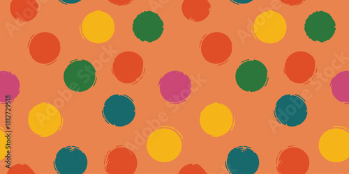 A seamless pattern of colorful polka dots scattered on a light orange background in a repetitive design
