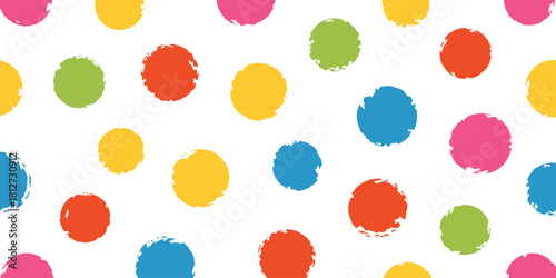 A seamless pattern of colorful polka dots scattered on a white background with a playful and vibrant feel