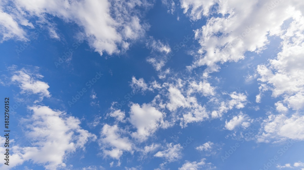 Obraz premium troposphere. Clear blue sky with fluffy white clouds creating a serene minimalistic background. travel magazines, destination branding, designed for outdoor magazines and nature guides.